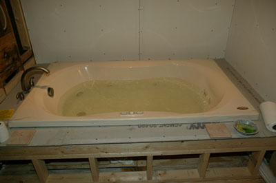 [Tub installed and being leak-tested]